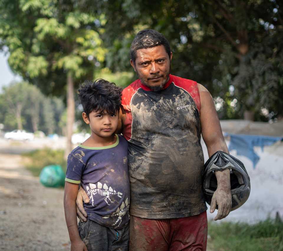 Young boy and man standing together