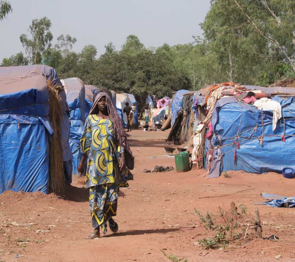 Woman walking through tents