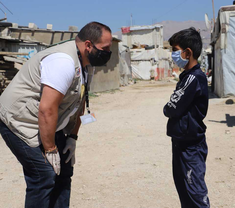 Young boy speaking with man